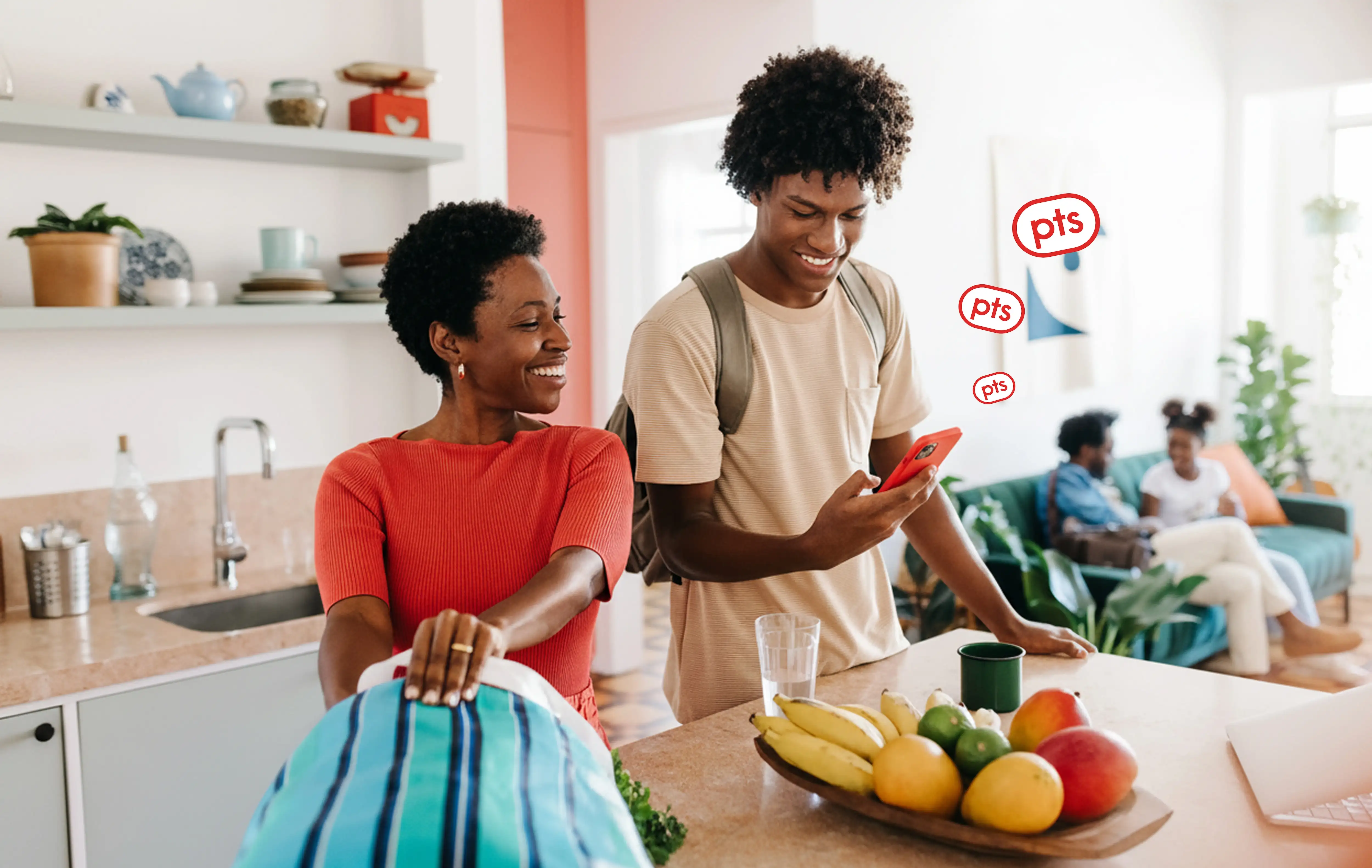 Man and woman looking at a phone in the kitchen
